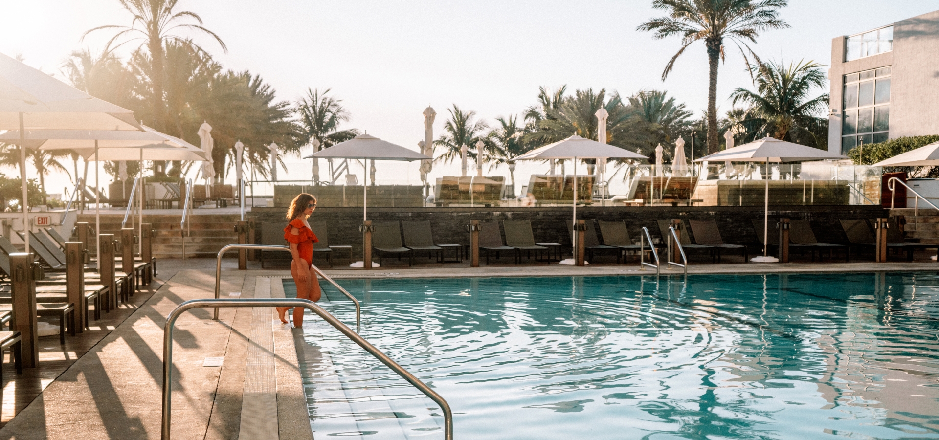 A woman entering the pool at Eden Roc, Miami Beach