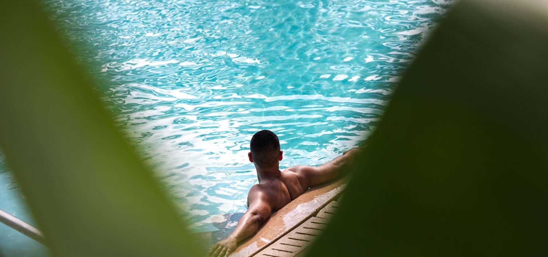 Guy in Pool with Fauna on foreground